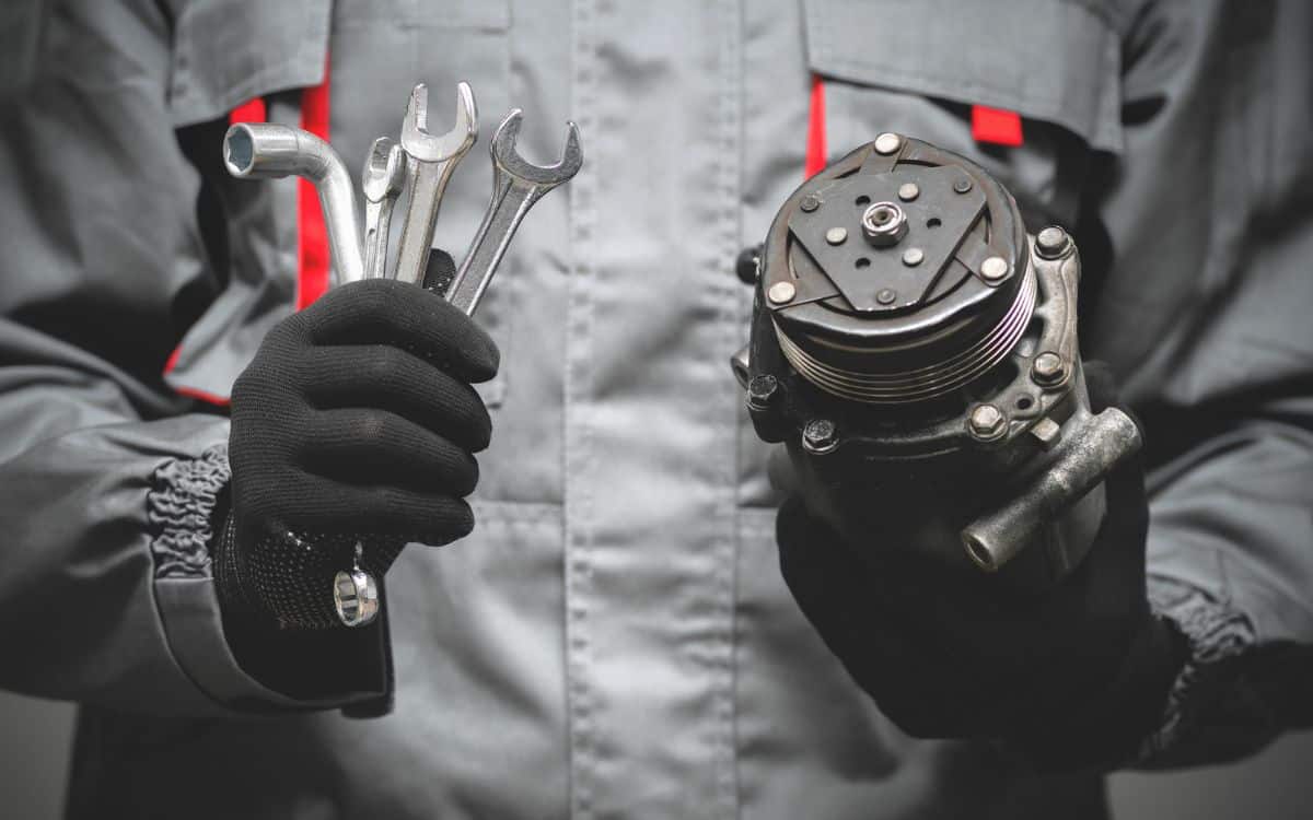 West Delray Collision Center onsite mechanic photo of mechanic holding tools and engine part West Delray Collision Center onsite mechanic photo of mechanic holding tools and engine part