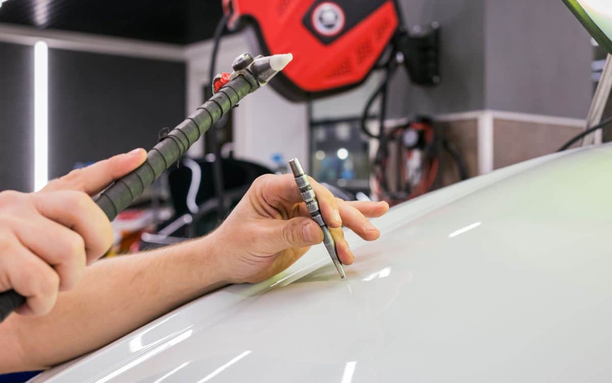 West Delray Collision Center photo of mechanic performing paintless dent repair on a car in Boca Raton, FL West Delray Collision Center photo of mechanic performing paintless dent repair on a car in Boca Raton, FL