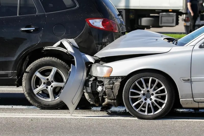 a grey car that had a rear end collision with a black SUV