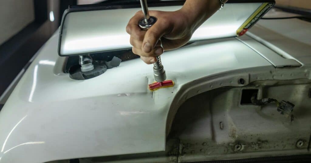 Precision dent repair during professional collision repair service