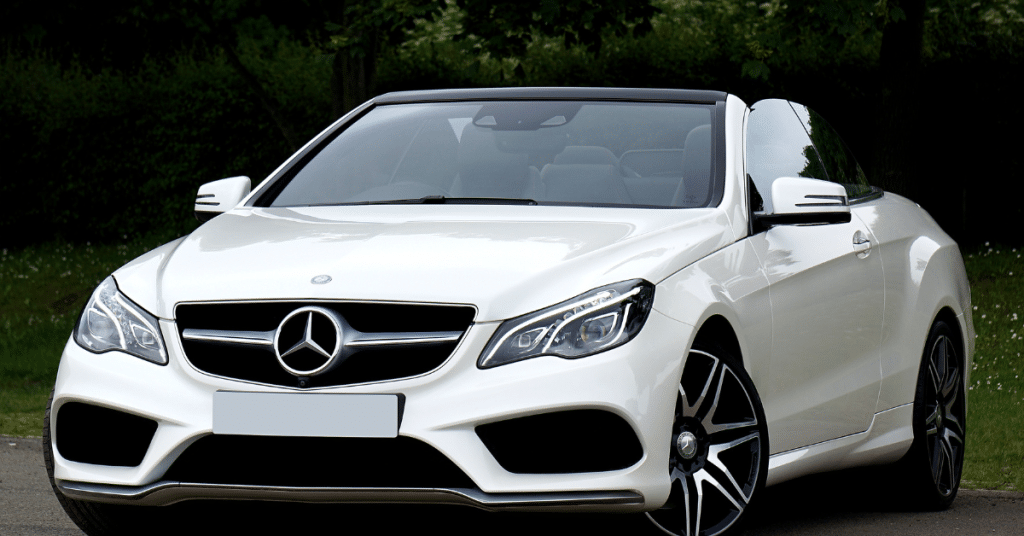 A white Mercedes-Benz E-Class Cabriolet with the top down, emphasizing luxury convertible maintenance and bodywork.