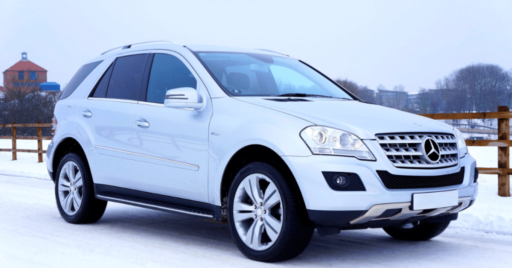 A silver Mercedes-Benz GLE SUV parked in a snowy environment, illustrating 4MATIC all-wheel-drive stability and rugged luxury design.